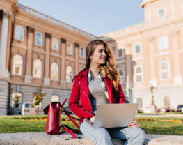 Dark-Haired Girl With Laptop Near University